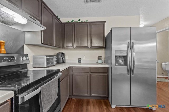 kitchen with dark brown cabinetry, dark hardwood / wood-style floors, and appliances with stainless steel finishes