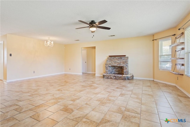 4409 Beach Ball Dr, Killeen, TX 76549 - unfurnished living room with ceiling fan, a chandelier, a stone fireplace, baseboards, and a textured ceiling