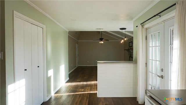 interior space featuring baseboards, vaulted ceiling, french doors, ornamental molding, and dark wood-style floors