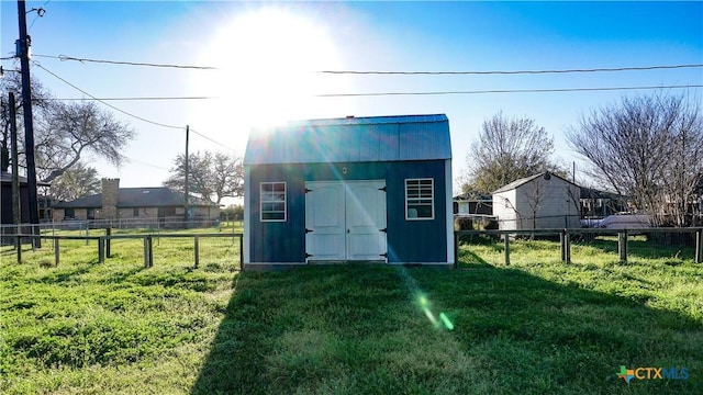 view of shed with fence