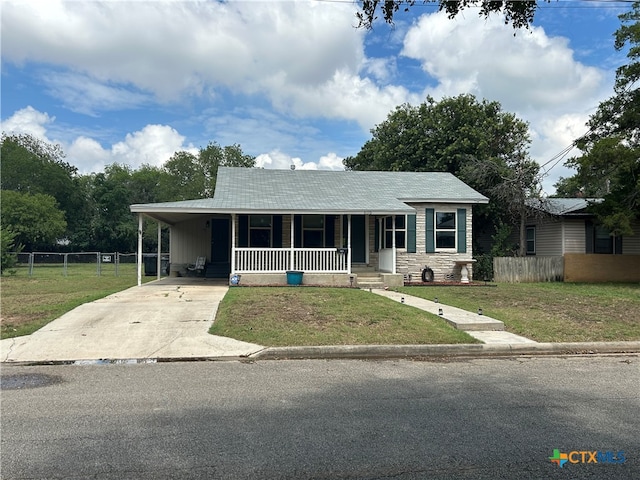 view of front of house with a porch, a front yard, and a carport