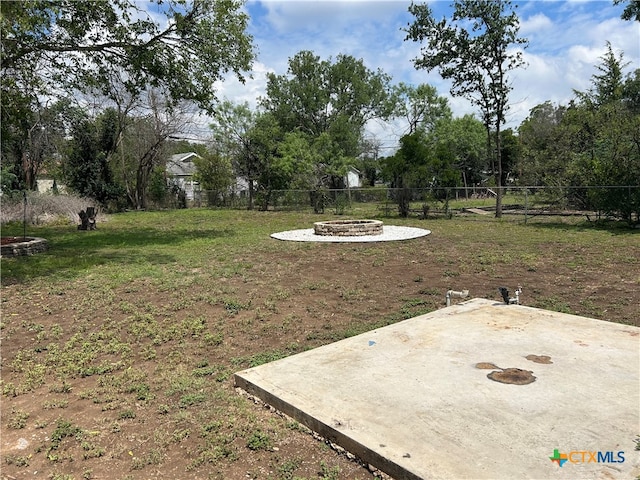 view of yard with a fire pit and a patio