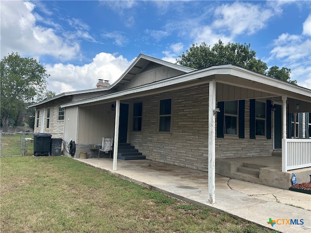 view of side of home featuring a lawn