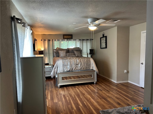 bedroom featuring ceiling fan, a textured ceiling, and dark hardwood / wood-style floors