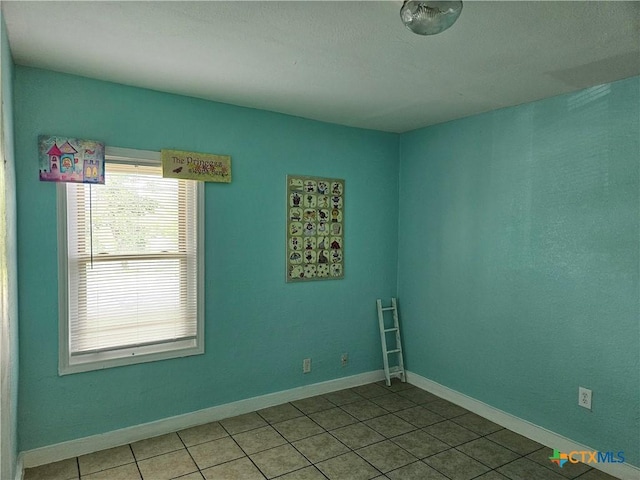 703 Atkinson Ave, Killeen, TX 76541 - tiled empty room with baseboards