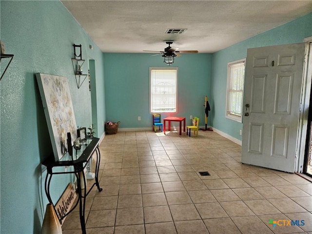 703 Atkinson Ave, Killeen, TX 76541 - entrance foyer with a ceiling fan, light tile patterned floors, and a textured wall