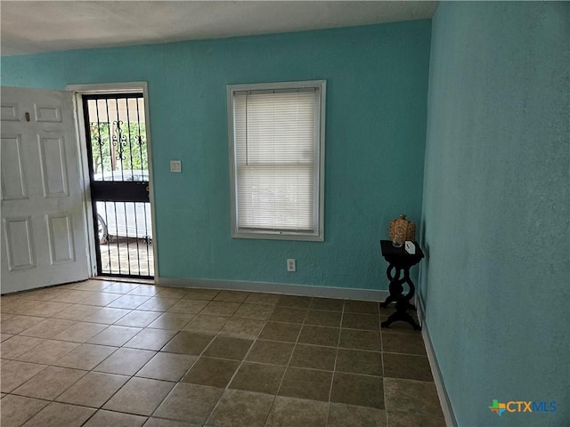 703 Atkinson Ave, Killeen, TX 76541 - foyer entrance featuring tile patterned flooring and a textured wall
