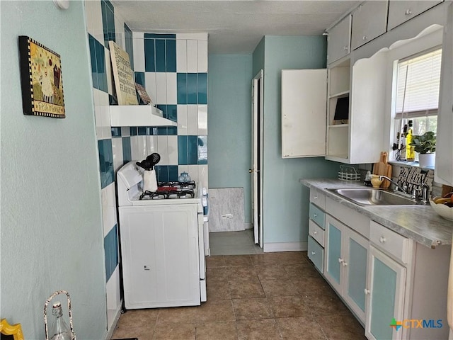 703 Atkinson Ave, Killeen, TX 76541 - kitchen with white range with gas cooktop and open shelves