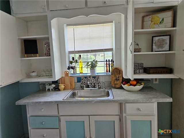 703 Atkinson Ave, Killeen, TX 76541 - kitchen featuring open shelves, white cabinetry, and light countertops