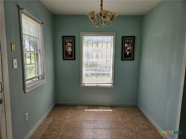 703 Atkinson Ave, Killeen, TX 76541 - spare room with healthy amount of natural light, a chandelier, a textured wall, and tile patterned floors