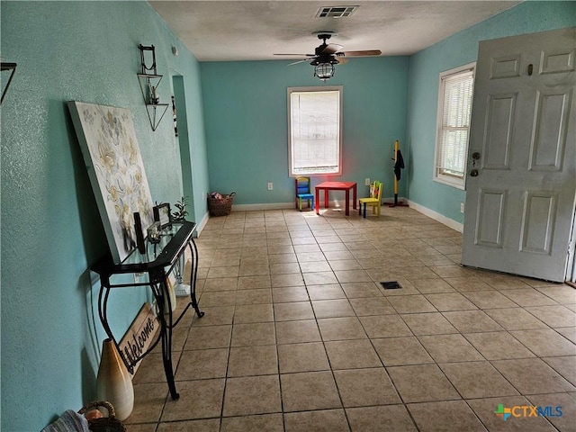 703 Atkinson Ave, Killeen, TX 76541 - tiled entryway featuring ceiling fan and a textured wall