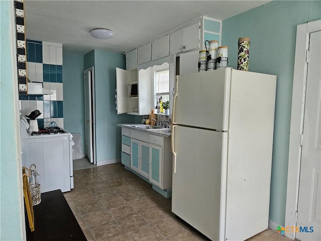 703 Atkinson Ave, Killeen, TX 76541 - kitchen featuring white appliances, wall chimney range hood, and a textured ceiling