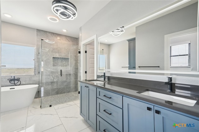 bathroom featuring a wealth of natural light, vanity, and independent shower and bath