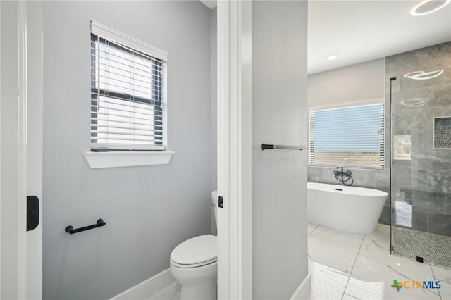 bathroom featuring toilet and independent shower and bath