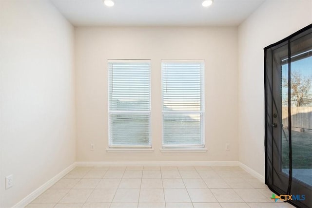 spare room featuring light tile patterned floors