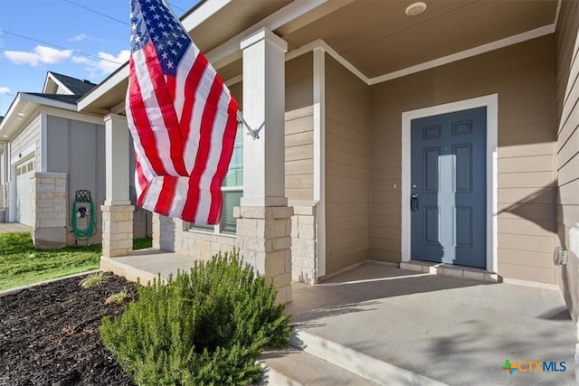 view of exterior entry with covered porch