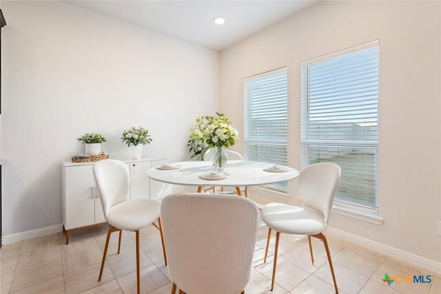 dining space featuring light tile patterned floors