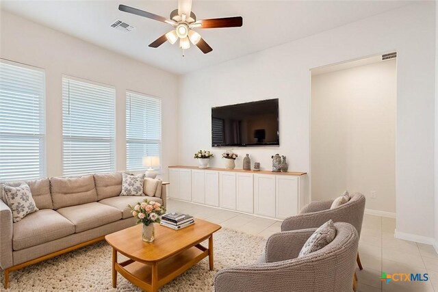 living room with ceiling fan and light tile patterned flooring