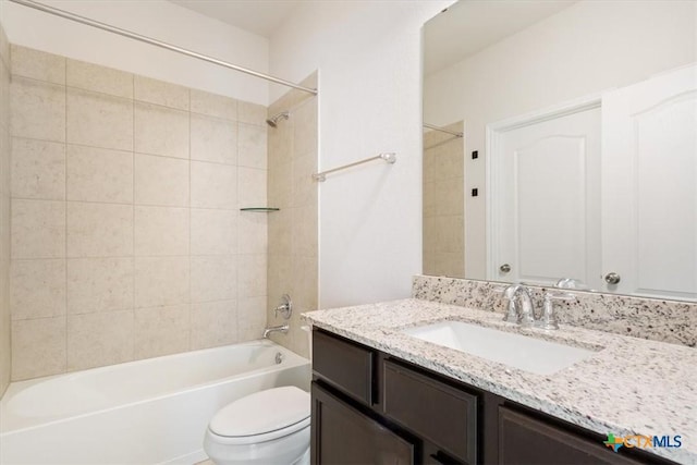 full bathroom featuring toilet, tiled shower / bath, and vanity