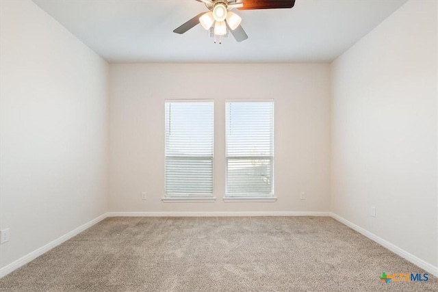 carpeted spare room with ceiling fan