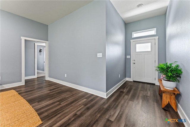 foyer with baseboards and dark wood-style floors