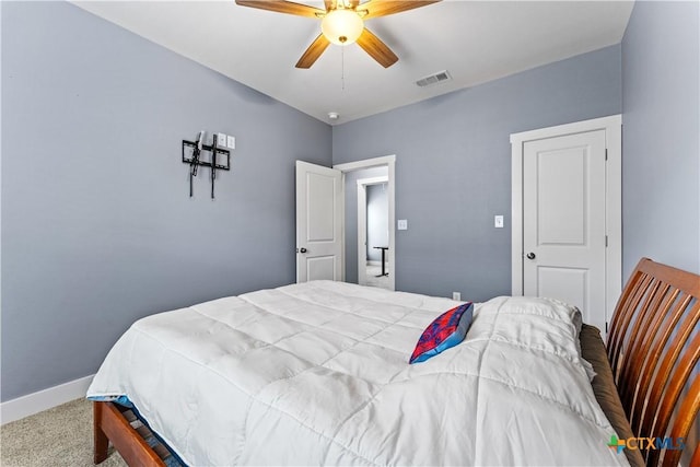 carpeted bedroom featuring visible vents, baseboards, and ceiling fan