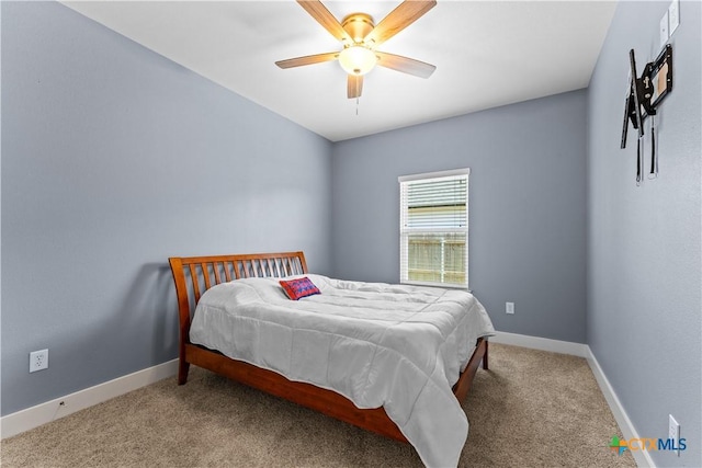 carpeted bedroom featuring a ceiling fan and baseboards