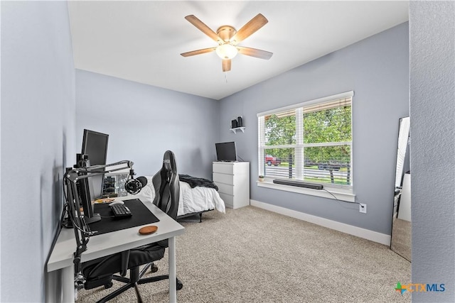 office space featuring ceiling fan, baseboards, and carpet