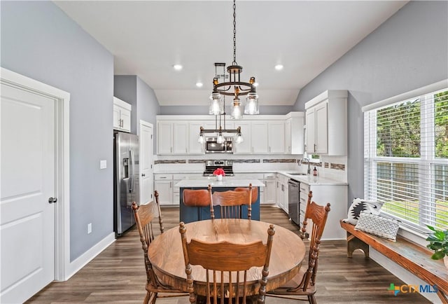 dining room featuring a chandelier, recessed lighting, dark wood finished floors, and baseboards