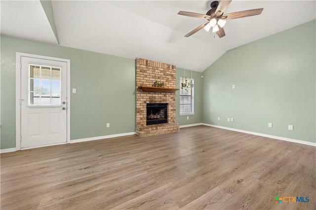 4408 Frontier Trl, Killeen, TX 76542 - unfurnished living room with lofted ceiling, ceiling fan, wood finished floors, and a brick fireplace