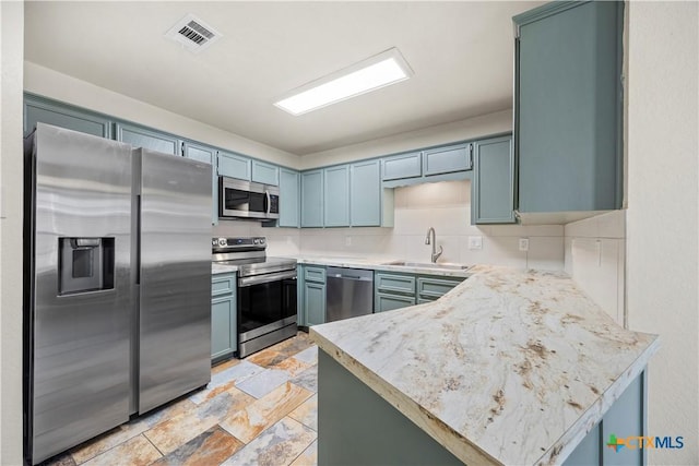 4408 Frontier Trl, Killeen, TX 76542 - kitchen with stainless steel appliances, stone tile flooring, light countertops, and a peninsula