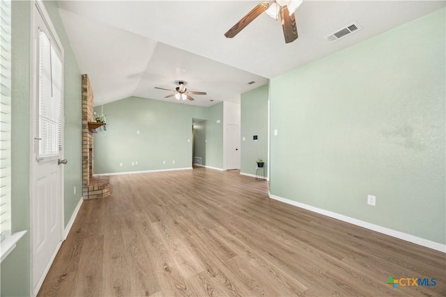 4408 Frontier Trl, Killeen, TX 76542 - unfurnished living room with a ceiling fan, light wood-type flooring, and vaulted ceiling