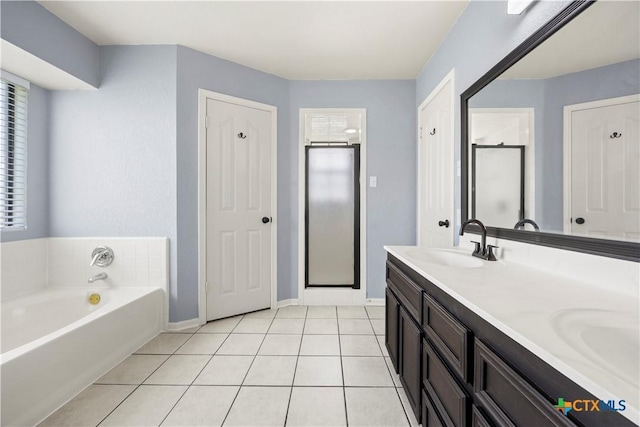 4408 Frontier Trl, Killeen, TX 76542 - bathroom with a bath, double vanity, tile patterned floors, and a shower stall