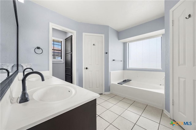 4408 Frontier Trl, Killeen, TX 76542 - full bath featuring double vanity, a garden tub, tile patterned floors, and healthy amount of natural light