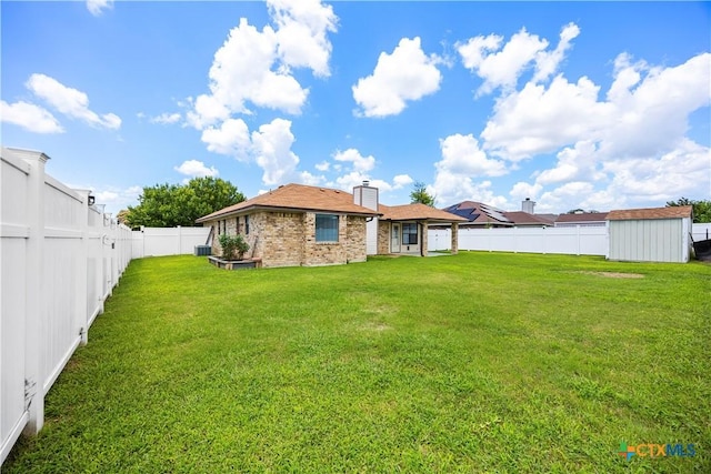 4408 Frontier Trl, Killeen, TX 76542 - back of property with a fenced backyard, a chimney, brick siding, and a storage shed