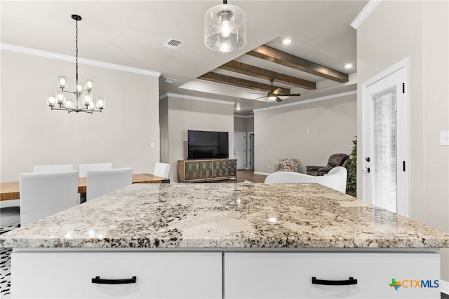 kitchen featuring ceiling fan with notable chandelier, white cabinetry, and decorative light fixtures