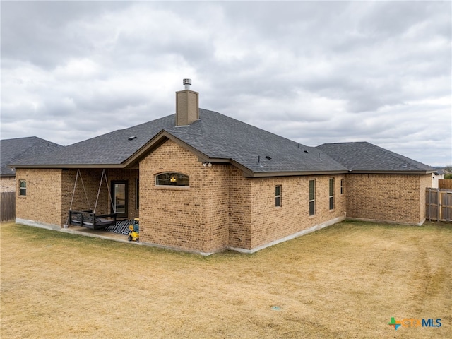 rear view of house with a patio area and a yard