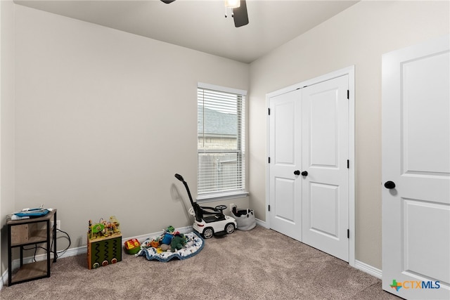 rec room featuring light colored carpet and ceiling fan