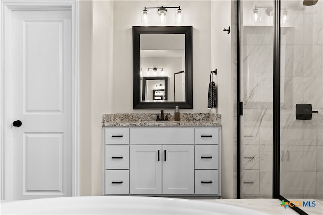 bathroom featuring vanity and an enclosed shower