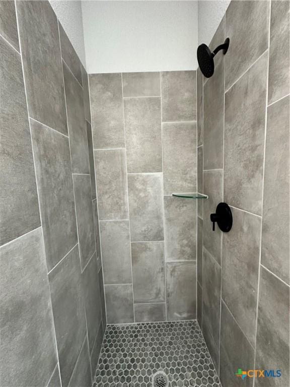 bathroom with a tile shower