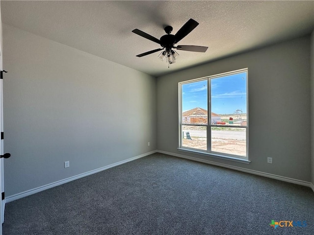 empty room featuring carpet, baseboards, a textured ceiling, and ceiling fan