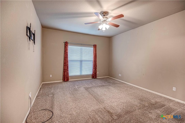 spare room with carpet flooring and ceiling fan