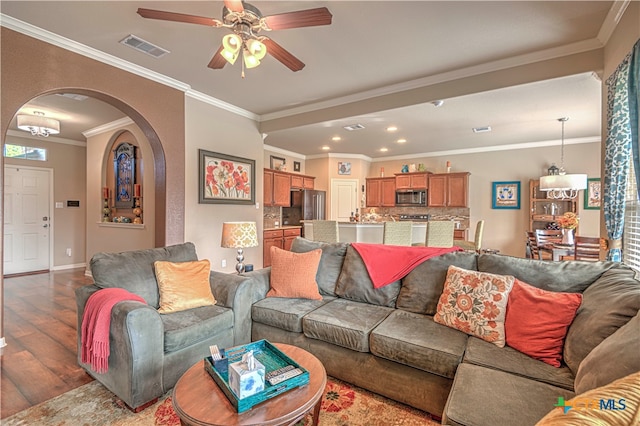 living room featuring crown molding, ceiling fan, and hardwood / wood-style flooring