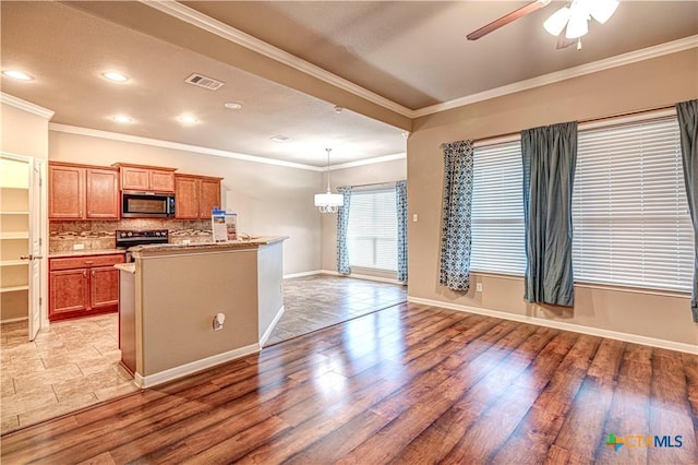 kitchen featuring decorative backsplash, crown molding, stainless steel appliances, and light wood-type flooring