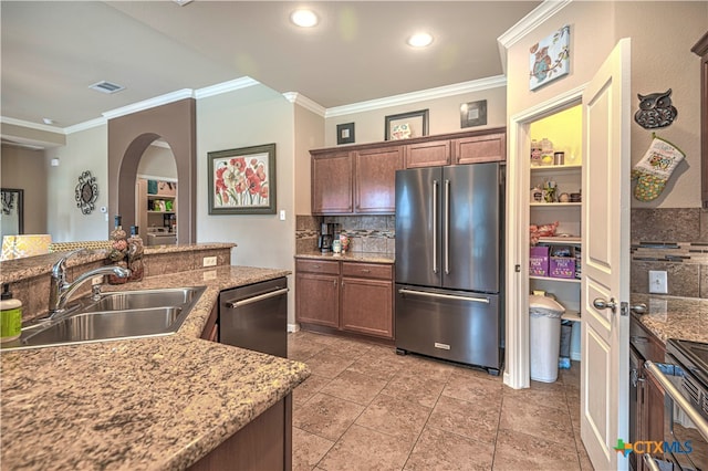 kitchen featuring tasteful backsplash, crown molding, sink, and stainless steel appliances