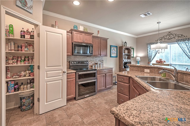 kitchen featuring sink, stainless steel appliances, and ornamental molding