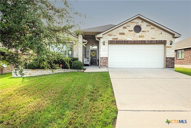 view of front of property with a garage and a front lawn