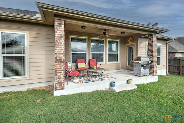 exterior space with ceiling fan, a yard, and a patio