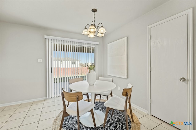 dining area with light tile patterned flooring and an inviting chandelier