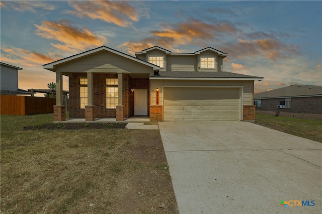 view of front of home featuring a lawn, covered porch, and a garage